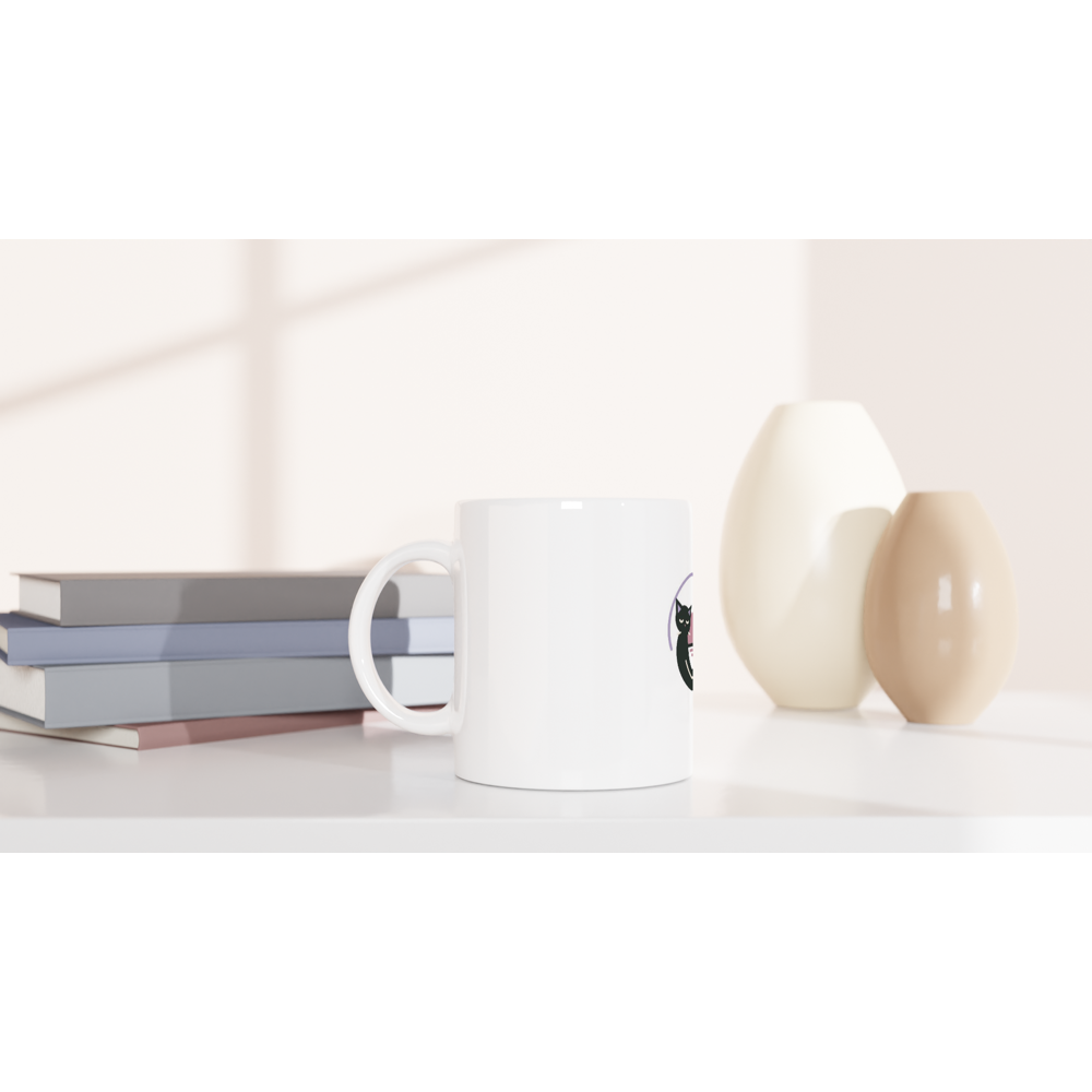 Morning Orbit white mug beside books and cream vases in a supplier mockup; handle on the left, with the artwork partly visible at the right edge.